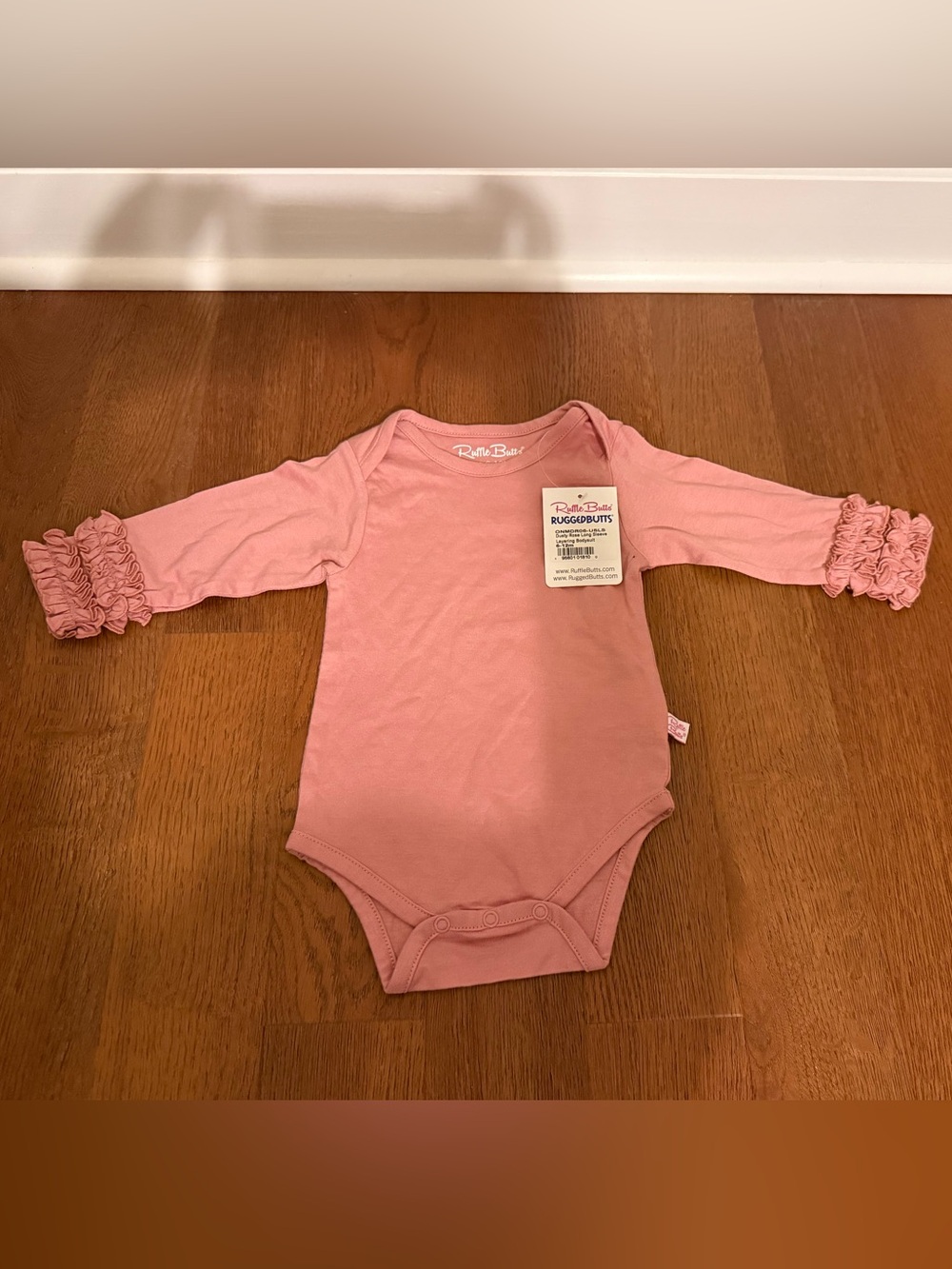 NWT RuffleButts Dusty Rose Ruffle Sleeve Bodysuit 6-12M Flaw